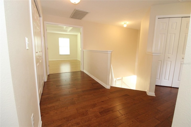 corridor featuring dark hardwood / wood-style floors