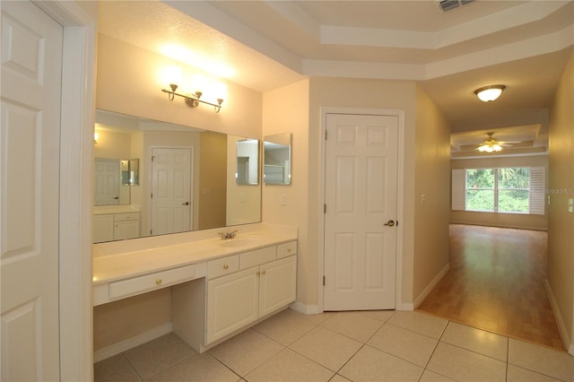 bathroom with visible vents, baseboards, a ceiling fan, tile patterned floors, and vanity