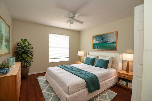 bedroom with ceiling fan and dark wood-type flooring