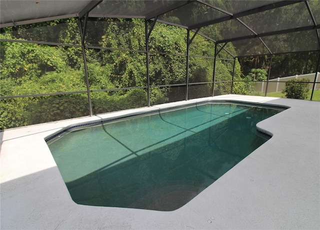 pool with glass enclosure and a patio