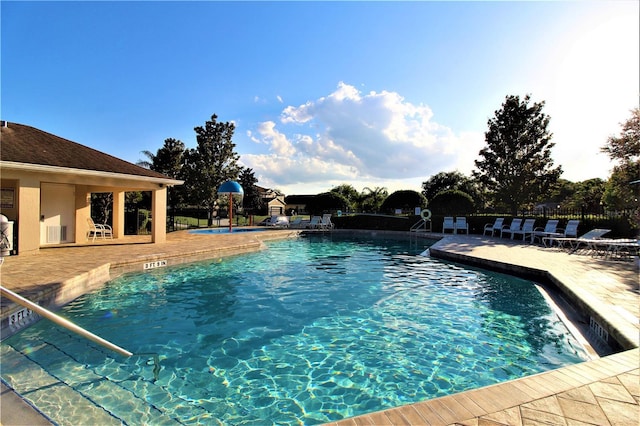 view of swimming pool with a patio area