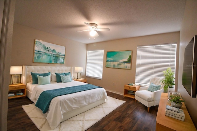 bedroom featuring ceiling fan, dark hardwood / wood-style floors, and a textured ceiling