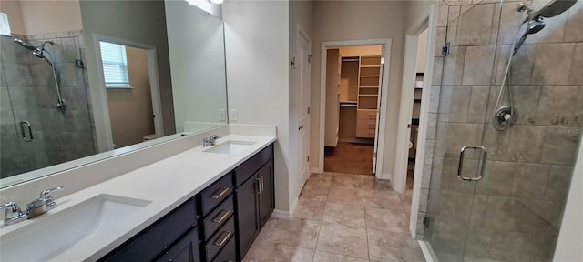 bathroom featuring vanity, an enclosed shower, and tile patterned floors