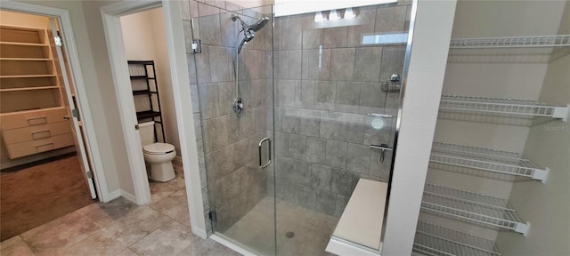 bathroom with tile patterned floors, toilet, and an enclosed shower