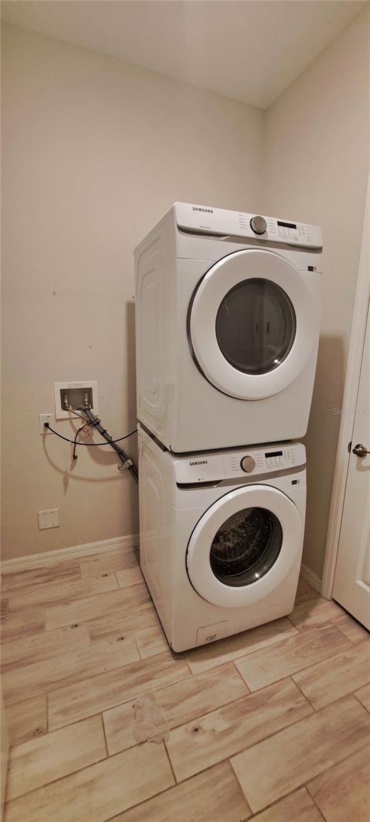 laundry area with stacked washer / drying machine