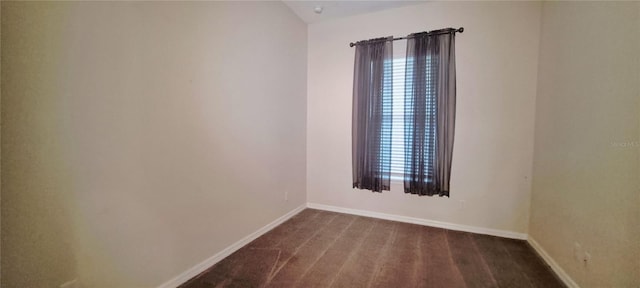 spare room featuring dark hardwood / wood-style flooring