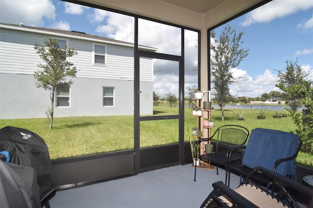 sunroom / solarium with a water view