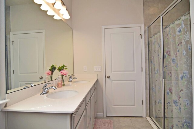 bathroom featuring vanity, a shower with shower door, and tile patterned floors