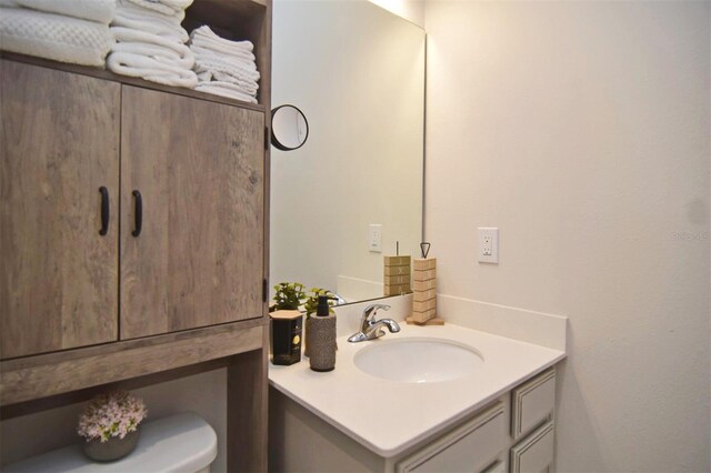 bathroom featuring vanity and toilet