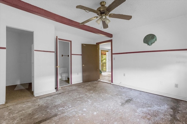 unfurnished bedroom with a textured ceiling, connected bathroom, and ceiling fan