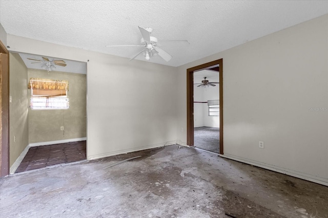 unfurnished room featuring ceiling fan and a textured ceiling