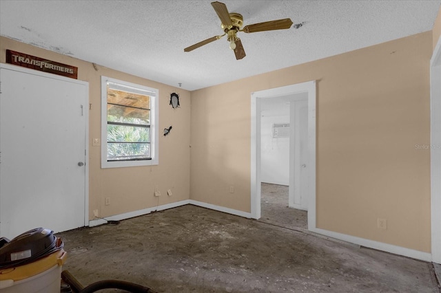 unfurnished room featuring ceiling fan and a textured ceiling