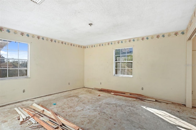 unfurnished room featuring a textured ceiling