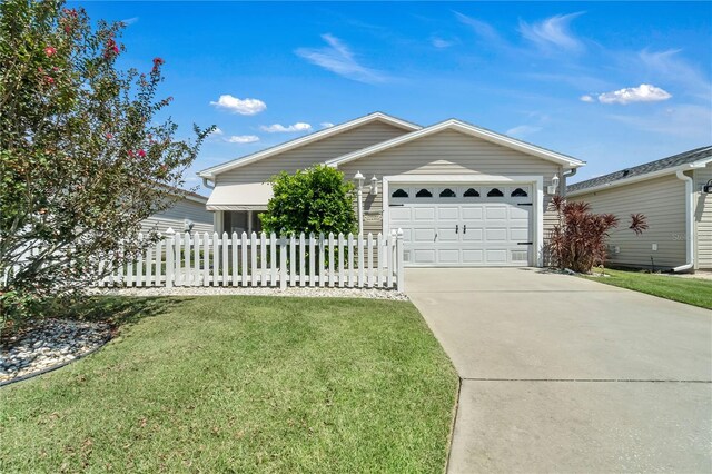 ranch-style home with a front lawn and a garage