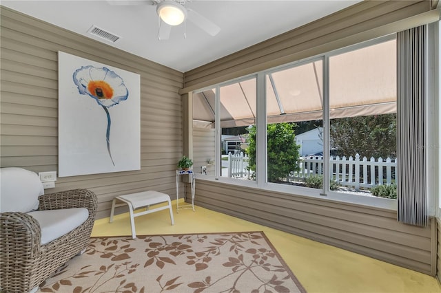 sunroom / solarium featuring ceiling fan