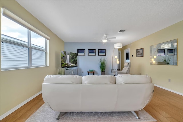 living room featuring ceiling fan and light wood-type flooring