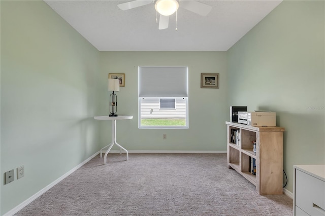 interior space with light colored carpet and ceiling fan