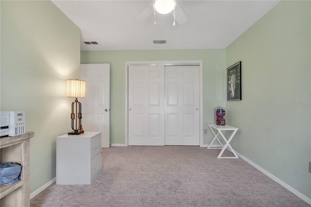 interior space with light colored carpet and ceiling fan