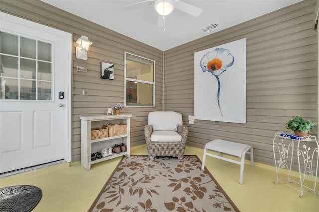 living area with ceiling fan