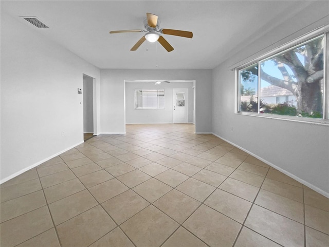 unfurnished living room featuring ceiling fan and light tile patterned flooring