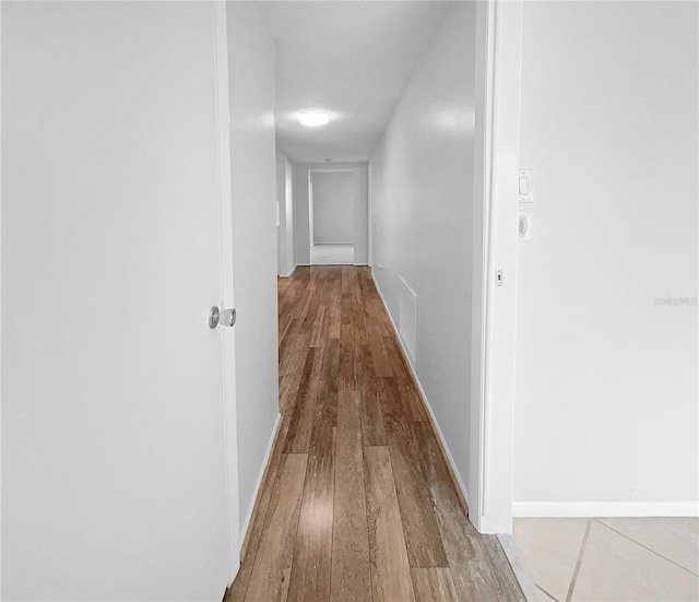 hallway with wood-type flooring