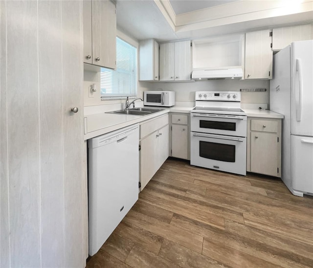 kitchen with dark hardwood / wood-style floors, sink, white appliances, and white cabinets