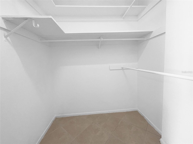 walk in closet with tile patterned floors