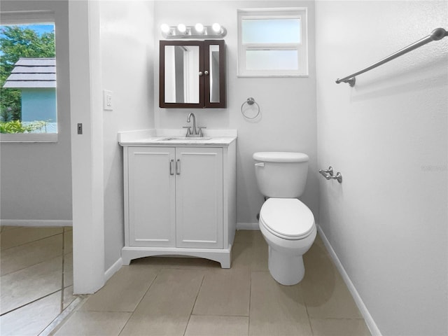 bathroom featuring toilet, vanity, and tile patterned floors