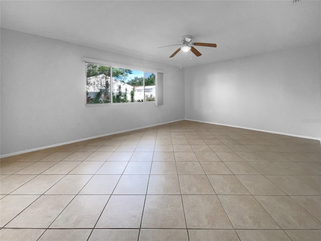 spare room featuring ceiling fan and light tile patterned floors