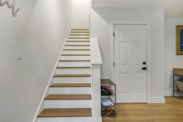 staircase featuring hardwood / wood-style flooring