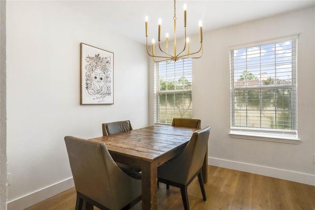 dining space with plenty of natural light, a notable chandelier, and light wood-type flooring