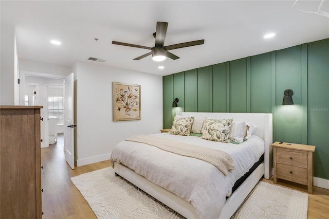 bedroom with ceiling fan and light hardwood / wood-style flooring