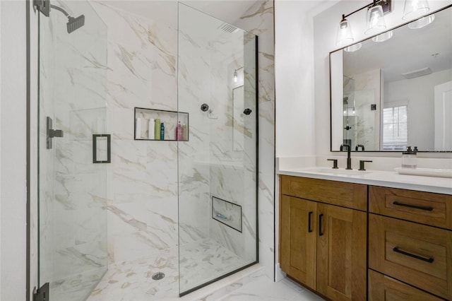 bathroom featuring tile patterned floors, an enclosed shower, and vanity