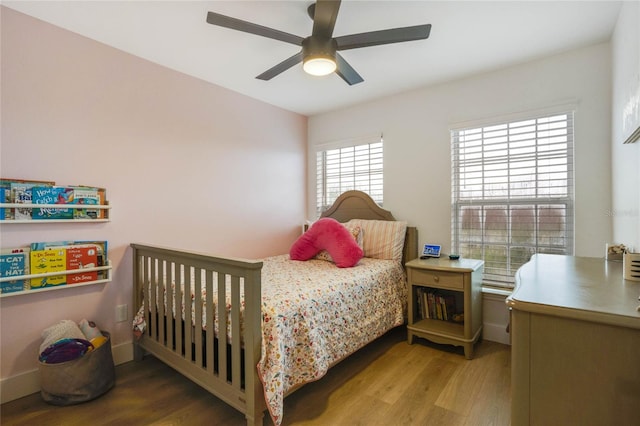 bedroom featuring light hardwood / wood-style floors and ceiling fan