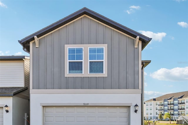 view of side of home featuring a garage