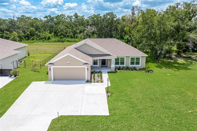 view of front of property featuring a garage and a front yard