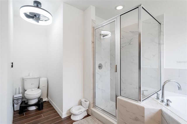 bathroom featuring wood-type flooring, toilet, and separate shower and tub