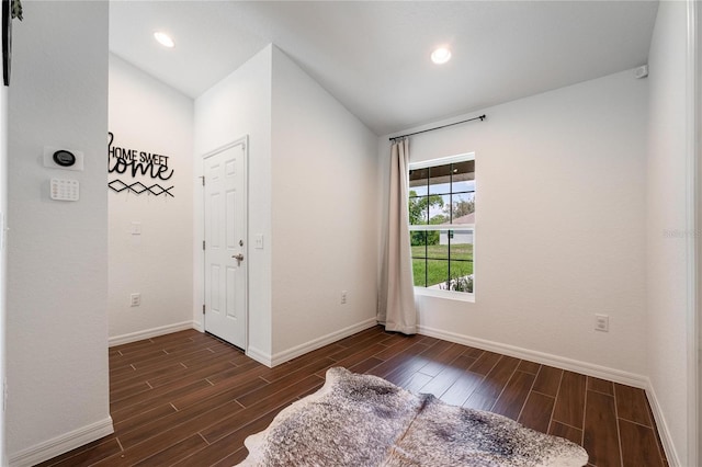 entryway featuring vaulted ceiling and dark hardwood / wood-style floors