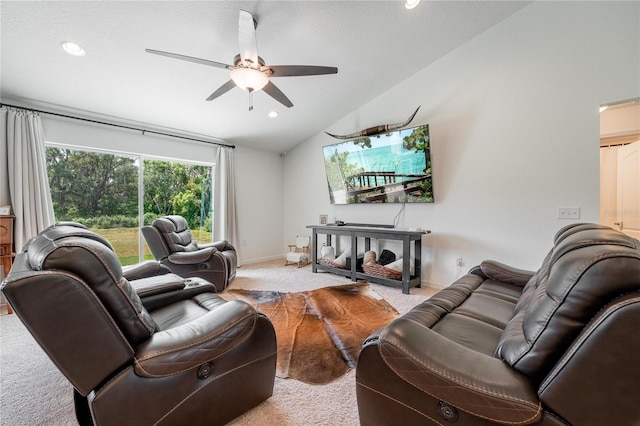 carpeted living room with ceiling fan and lofted ceiling