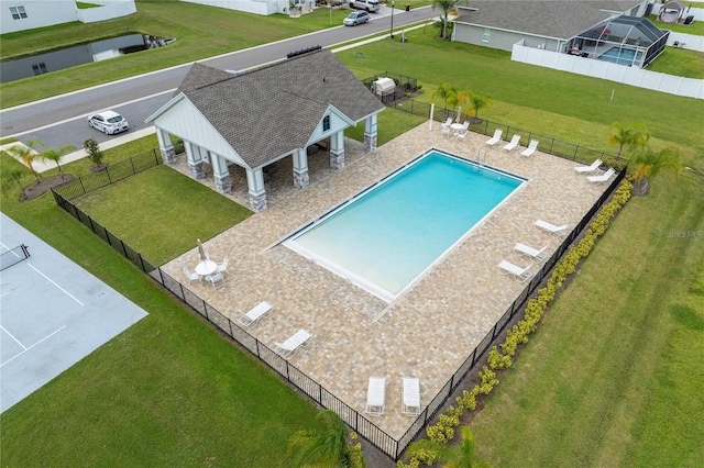 view of swimming pool featuring a patio area and a yard