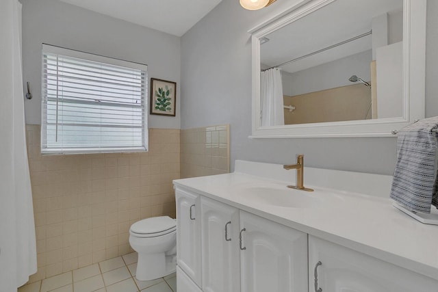 bathroom featuring tile walls, curtained shower, toilet, vanity, and tile patterned flooring