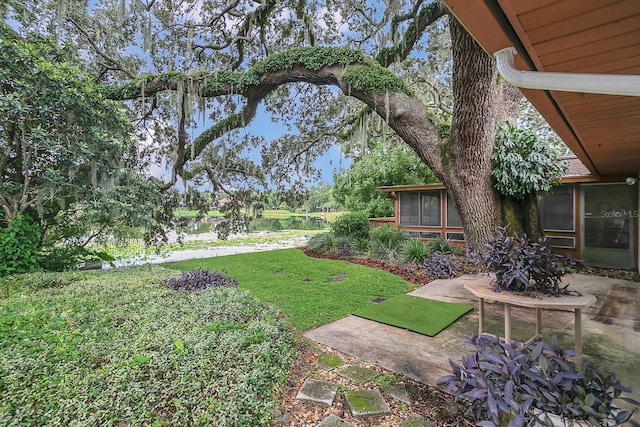 view of yard with a sunroom and a patio