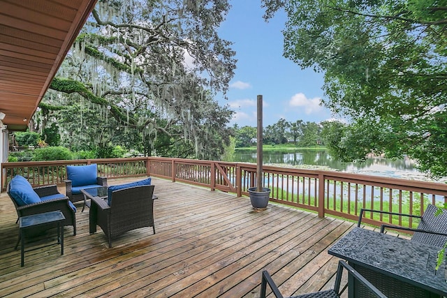 wooden terrace featuring a water view and an outdoor living space