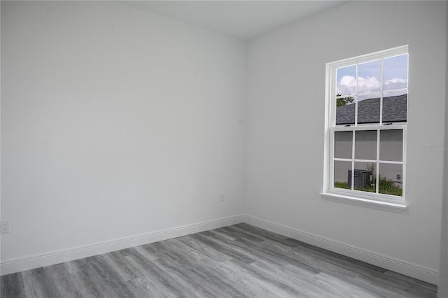 unfurnished room with hardwood / wood-style flooring