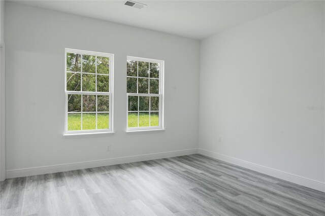 unfurnished room with wood-type flooring