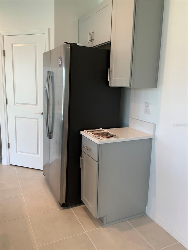 5639 Costa Blanca Way, Davenport, FL 33897 - kitchen featuring gray cabinets, light countertops, light tile patterned flooring, and stainless steel fridge with ice dispenser