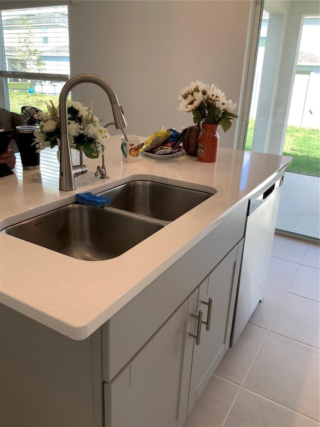5639 Costa Blanca Way, Davenport, FL 33897 - kitchen view of a sink, light stone countertops, and white cabinetry