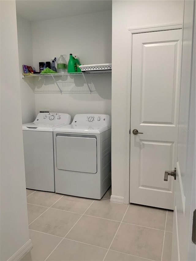 5639 Costa Blanca Way, Davenport, FL 33897 - laundry room featuring washer and dryer, light tile patterned floors, and baseboards