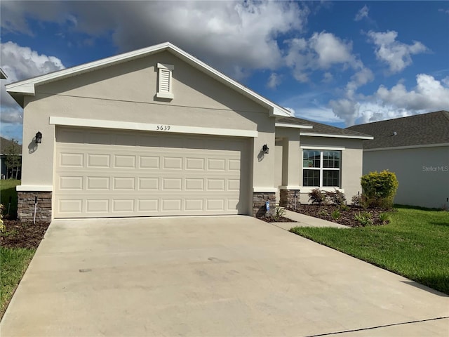 5639 Costa Blanca Way, Davenport, FL 33897 - single story home featuring stone siding, stucco siding, driveway, and a garage