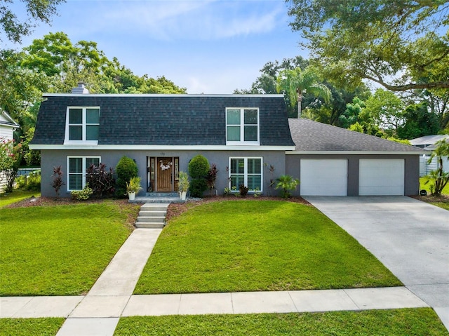 view of front of house with a garage and a front lawn